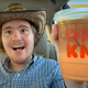 Man in cowboy hat holding up peanut butter macchiato